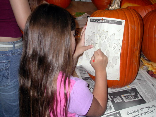 Kimmy Carving Pumpkins by Josh Poulson